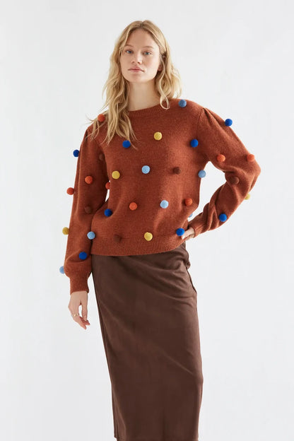 Brown knit sweater with multicolored pompoms