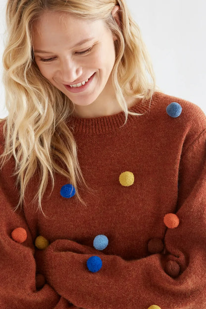 Brown knit sweater with multicolored pompoms